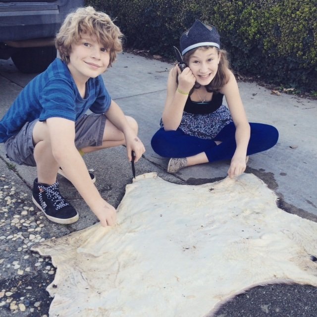 "What? We're making moccasins." (cutting the fat off the hide)